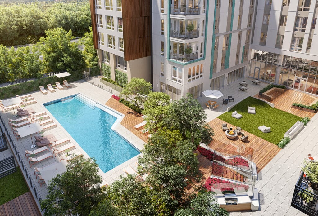 Aerial view of a landscaped courtyard featuring a swimming pool, lounge chairs, fire pit, and lush greenery.